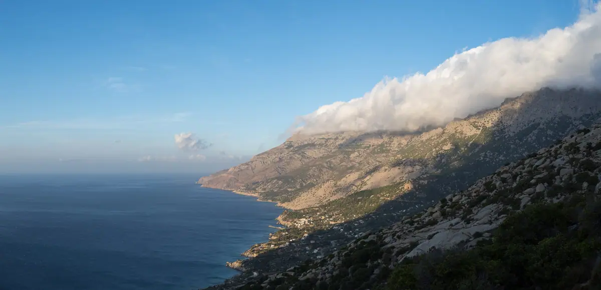 Sun rising over the hill and onto the southern Icarian coastline, Magganitis, Ikaria, Greece